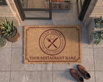 May include: A rectangular tan coir doormat with a dark red border and a central circular emblem featuring a chef hat, a fork, and a knife. The text reads FINE DINING, EST. 1998, and YOUR RESTAURANT NAME in a dark red sans-serif font.