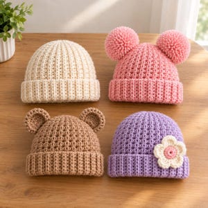 May include: Four crocheted beanies in different colors and designs. One is cream, one is pink with two large pom-poms, one is brown with small bear ears, and one is purple with a white and pink crocheted flower attached to the side of the hat.