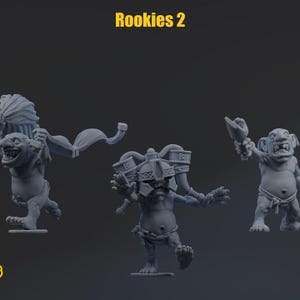 May include: Three grey unpainted miniature goblin figures labeled Rookies 2. The left figure holds a banner, the center figure wears a large ornate helmet with two canisters, and the right figure holds a cup. Each figure has a stout build.