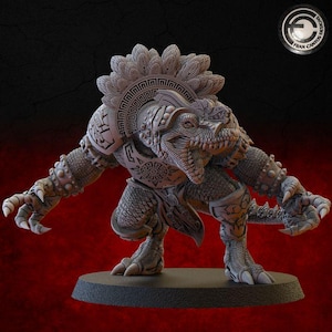 May include: A detailed, gray figurine of a reptilian humanoid creature in a crouching pose. The figure has intricate armor and a headdress with geometric patterns. The creature's claws and scales are visible. The base is dark gray.
