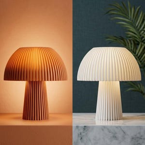 May include: A mushroom-shaped table lamp with a ribbed, fluted exterior. The lamp is shown in two variations: one emitting a warm, orange-toned light and the other emitting a cool, white light, both featuring a consistent vertical grooved texture.