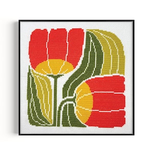 May include: Framed needlepoint art featuring a stylized floral design. The artwork showcases two red tulips with yellow centers and green leaves against a white background. The piece is framed in a black square frame.