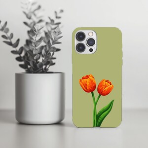 May include: A sage green phone case featuring a watercolor illustration of two orange tulips with green leaves. The case is next to a silver pot with a plant.