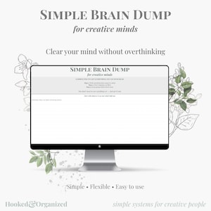 May include: A computer monitor displaying a Simple Brain Dump template for creative minds. The screen shows text instructions for clearing the mind, with floral illustrations on the sides. The text reads Simple Brain Dump, for creative minds, Clear your mind without overthinking, Simple, Flexible, Easy to use, and Hooked & Organized.
