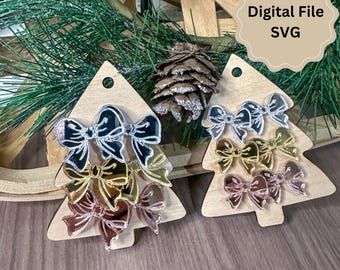 May include: Two wooden Christmas tree shapes with three different colored bows on each. The bows are silver, gold, and rose gold. The text "Digital File SVG" is on a white tag.