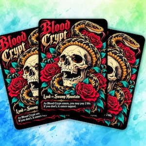 May include: Three rectangular trading cards featuring the text Blood Crypt, Land - Swamp Mountain, and game rules. The artwork displays a human skull entwined by a yellow and black snake, surrounded by vibrant red roses and teal leaves.