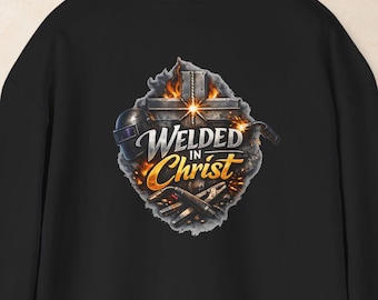 May include: A black hooded sweatshirt featuring a graphic on the back. The design displays a cross, welding tools, and flames with the text "WELDED IN CHRIST" in white and orange lettering. The hoodie has long sleeves and a hood.