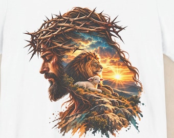 May include: A white short-sleeve t-shirt featuring a graphic print of a profile view of a person wearing a crown of thorns, with a lion and a lamb positioned in front of a sunset landscape within the silhouette of the head.