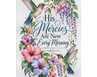 May include: A rectangular white tea towel featuring two hummingbirds, pink and purple hibiscus flowers, and purple wisteria. The text reads: His Mercies Are New Every Morning LAMENTATIONS 3:22-23, written in a dark blue script and serif font.