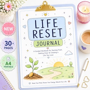 May include: A light blue clipboard holding a Life Reset Journal with a gold clip. The cover features a sunrise, a sprouting plant, and text reading Life Reset Journal, A Guided Workbook for Starting Fresh, Getting Clear & Creating a Life You Love.
