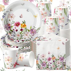 May include: A set of white paper party supplies featuring a floral and butterfly design. The set includes plates, cups, and napkins with colorful flowers in pink, yellow, and purple. Butterflies are scattered throughout the design, creating a whimsical look.