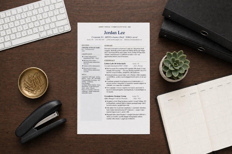May include: A resume titled "Jordan Lee" is centered on a dark wood desk, surrounded by office supplies. A white keyboard, stapler, gold paperclip dish, succulent plant, and a notebook are visible.