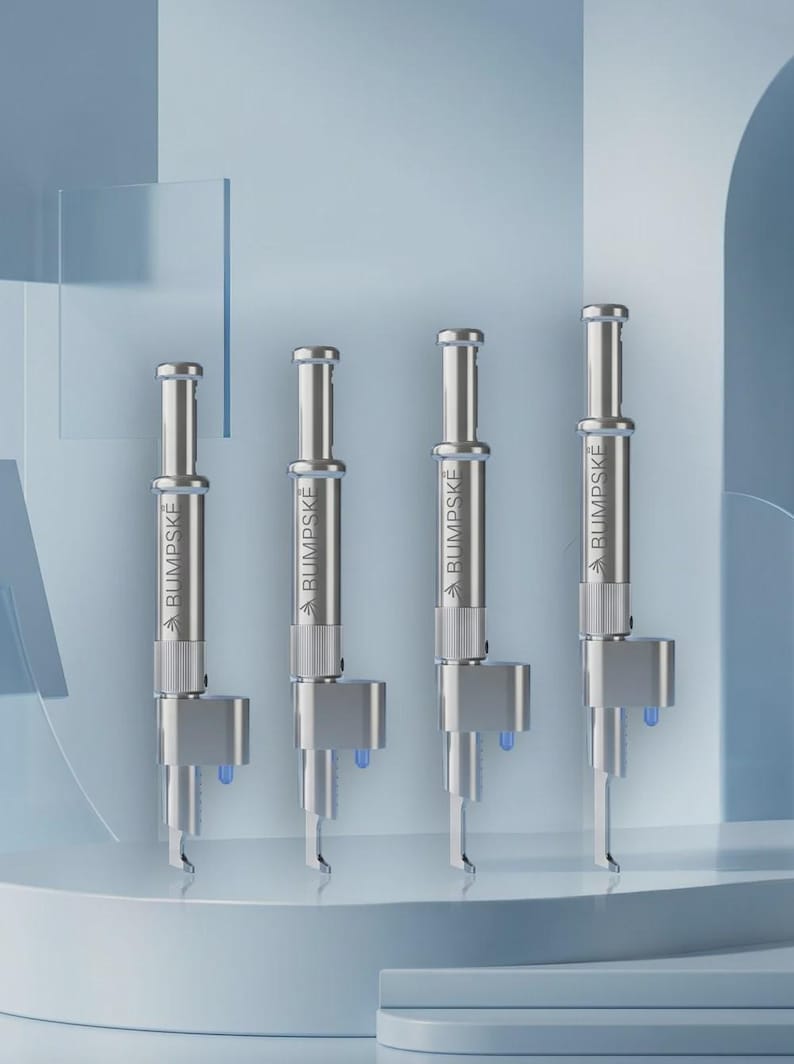 May include: Four identical silver-toned metal tools arranged in a row, each featuring a cylindrical body with the text BUMPSKE printed vertically, a knurled grip section, a protruding side component, and a small blue light element at the base.