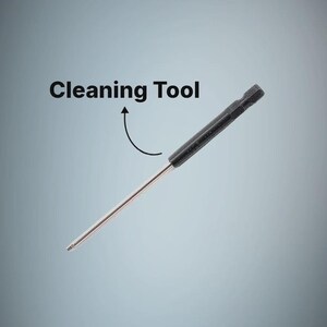 May include: A slender cleaning tool featuring a long, thin metallic rod attached to a black, hexagonal-shaped handle. The text Cleaning Tool is printed above the object with a curved arrow pointing toward the black handle section of the device.