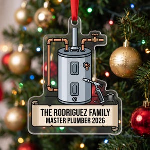 May include: A clear acrylic Christmas ornament featuring a graphic of a grey water heater with copper pipes and a soldering torch. A scroll banner at the bottom displays the text THE RODRIGUEZ FAMILY MASTER PLUMBER 2026 in black capital letters.