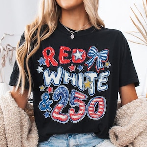 May include: Black t-shirt with the text "RED WHITE & 250" in red, white, and blue, with star and bow graphics. The shirt is a casual style, suitable for patriotic events.