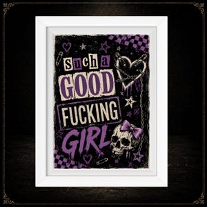 May include: A framed wall art print featuring a black background with purple and white text that reads "such a GOOD FUCKING GIRL". The design includes a skull with a purple bow, a heart pierced by safety pins, chains, stars, and checkered patterns.