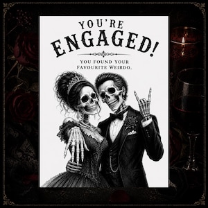 May include: Black and white engagement announcement featuring a skeletal bride and groom. The bride wears a tiara and gown, while the groom is in a tuxedo. Text reads "You're Engaged! You found your favourite weirdo."