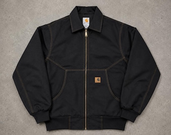 Veste Carhartt Detroit style vintage : manteau workwear en toile noire délavée
