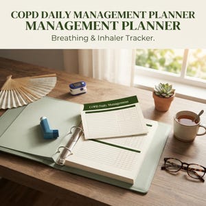 May include: A light green three-ring binder containing pages titled COPD Daily Management with a breathing and inhaler tracker. The binder is accompanied by a blue inhaler, a pulse oximeter, a folding fan, a succulent, a mug, and glasses.