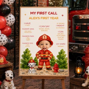 May include: A rectangular milestone sign titled MY FIRST CALL ALEX'S FIRST YEAR featuring a cartoon child in a red firefighter uniform and a dalmatian puppy. The sign lists developmental milestones, favourite foods, songs, and physical stats in inches and pounds.