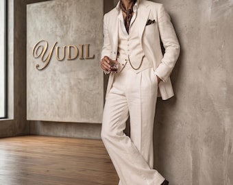 May include: A cream-colored three-piece suit with a vest, jacket, and wide-leg pants. The suit is paired with a brown patterned scarf and dark brown shoes. The word "YUDIL" is displayed in gold script on a gray background.