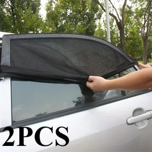May include: A black mesh car window sun shade designed to cover the side window of a vehicle. The flexible fabric screen features a dark, semi-transparent material with a reinforced border. The text 2PCS is displayed in the lower left corner.