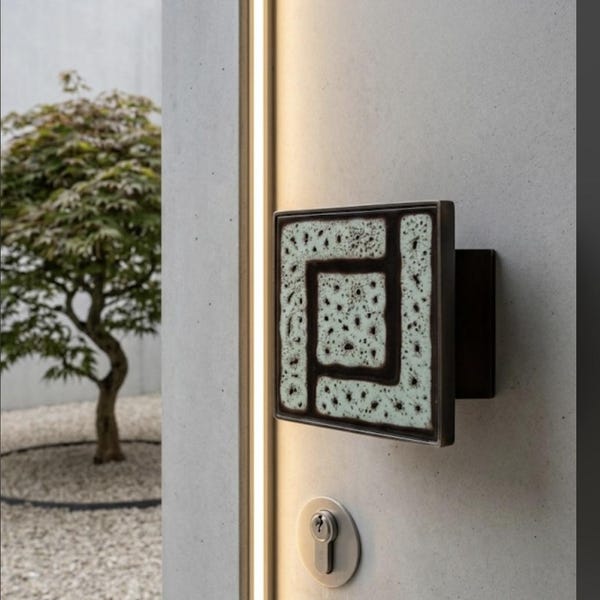 Vintage ceramic tile and front door handle from the 1970s.