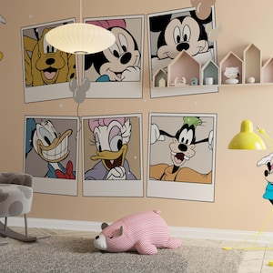 May include: A wall decal set featuring six large polaroid-style frames with illustrations of Disney characters including Mickey Mouse, Minnie Mouse, Pluto, Donald Duck, Daisy Duck, and Goofy, plus additional individual character stickers on a beige wall.