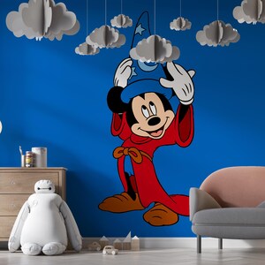 May include: A large wall decal featuring Mickey Mouse dressed as a sorcerer in a red robe and blue hat with a moon and star design. The character is positioned on a solid blue wall, surrounded by several hanging three-dimensional paper clouds.
