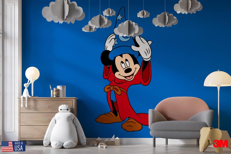 May include: A large wall decal featuring Mickey Mouse dressed as a sorcerer in a red robe and blue hat with a moon and star design. The character is positioned on a solid blue wall, surrounded by several hanging three-dimensional paper clouds.