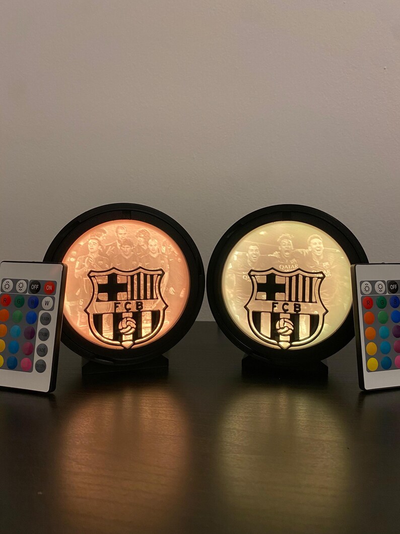 Puede incluir: Dos l&aacute;mparas circulares iluminadas con el logotipo del FC Barcelona y una foto del equipo. Cada l&aacute;mpara tiene un marco negro y un mando a distancia para ajustar el color. L&aacute;mparas decorativas.