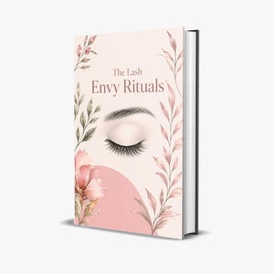 May include: A book titled "The Lash Envy Rituals" with a light pink cover. The cover features a watercolour illustration of a closed eye with long lashes, floral accents, and a pink circular shape.