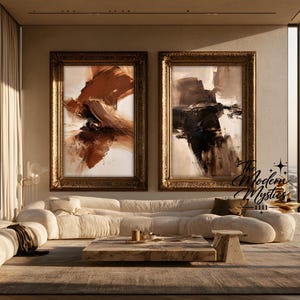 May include: Two large rectangular abstract paintings in ornate gold frames hanging side by side. The left painting features swirling strokes of deep brown and cream, while the right painting displays bold black and brown brushwork. Text reads The Modern Mystics 1111.