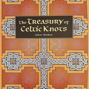 May include: A softcover book titled The Treasury of Celtic Knots by Aidan Meehan, published by Thames & Hudson. The cover features an intricate, symmetrical pattern of interlocking grey and white Celtic knots over a vibrant orange and red background.