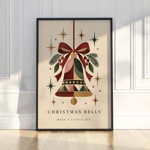 May include: A framed wall art print featuring a central bell illustration in shades of red, green, and gold, adorned with a red bow and pine sprigs. The text reads CHRISTMAS BELLS and MAKE A LITTLE JOY, surrounded by gold and red starburst accents.
