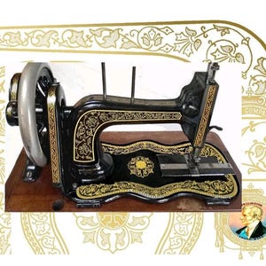 May include: A black vintage sewing machine featuring intricate gold floral decals and scrollwork patterns. The machine has a silver handwheel, a needle bar, and two vertical spool pins, all mounted on a rectangular wooden base with a smooth finish.