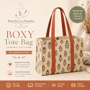 以下が含まれることがあります： StitchEasyStudioのボックス型トートバッグの縫製パターン。クリーム色の生地に錆色と緑色の花柄が繰り返されています。バッグには2本の錆色のストラップがあり、完成サイズは幅38cm、高さ30cm、奥行き14cmと記載されています。