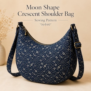 May include: A crescent-shaped shoulder bag featuring a dark blue fabric with a white floral wave pattern, a brass-toned zipper, and adjustable straps. The text above reads Moon Shape Crescent Shoulder Bag Sewing Pattern.