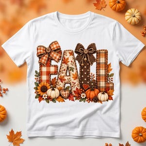 May include: A white t-shirt featuring the word FALL in large, decorative letters. Each letter has a unique pattern including plaid, autumn leaves, and polka dots. The design is accented with bows, pumpkins, sunflowers, and fall foliage.