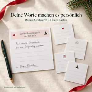 May include: A set of white stationery cards with festive icons including a heart, coffee mug, gift, and Christmas tree. The largest card features the German text "Ein Weihnachtsgru&szlig; nur f&uuml;r dich" and "Deine Worte machen es pers&ouml;nlich". A dark green pen is included.