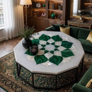 May include: An octagonal coffee table with a white marble top inlaid with a green and white floral design. The table has a black metal frame and is set in a luxurious living room with a green rug and sofa.