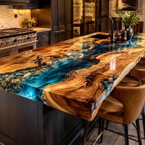 Könnte beinhalten: Eine Kücheninsel-Arbeitsplatte aus natürlichem Baumkantenholz mit einem zentralen Fluss aus durchscheinendem blauem Epoxidharz. Die Oberfläche ist hochglänzend poliert und zeigt die Holzmaserung sowie das blaue Flussdesign.