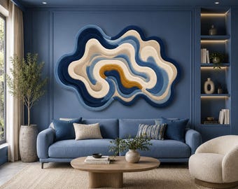 May include: A large, irregular, cloud-shaped wall hanging featuring layered, flowing abstract patterns in shades of deep navy blue, light blue, cream, and a single accent of mustard yellow, creating a textured, three-dimensional appearance.