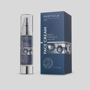 May include: A skincare product set featuring a pump bottle and a box. The bottle and box are navy blue with white text that reads "Particle Men's Formula Daily Care Face Cream." The box also displays the text "Aesthetic Science for Men."