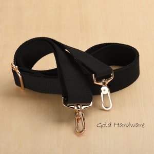 May include: Black canvas adjustable strap with gold hardware and two swivel hooks.  Gold Hardware.