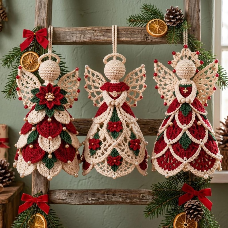 May include: Three crocheted angel ornaments hanging from a wooden ladder. Each angel features cream, red, and green yarn with small white beads. The angels have intricate lace-like wings, detailed skirts with floral motifs, and halos. The ladder is decorated with pine branches, dried orange slices, and red bows.