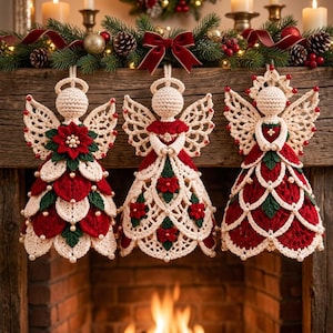May include: Three crocheted angel ornaments featuring cream-colored yarn bodies with intricate lace wings, red and green floral accents, and small white pearl beads. Each angel has a halo and is suspended by a loop, showcasing detailed needlework.