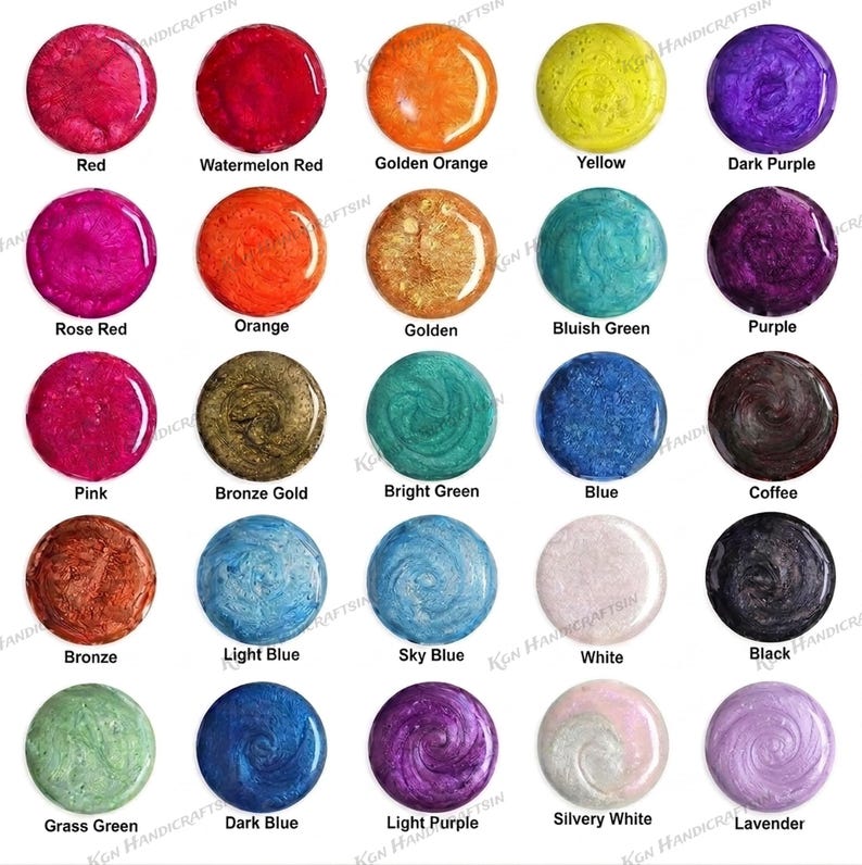 May include: A selection of 24 circular resin samples in various colours, each labelled with its name. Shades include red, orange, yellow, purple, green, blue, brown, white, and black. The text "KGN HANDICRAFTSIN" is visible.