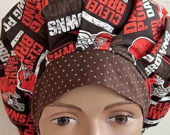 May include: A brown and orange scrub hat with a white and brown polka dot pattern. The hat features a repeating pattern of the words "Cleveland Browns" and "Browns".